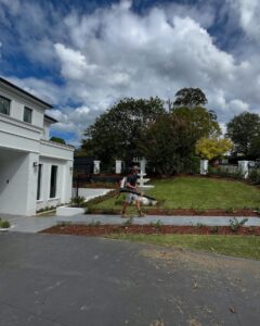 Front garden and mown lawn of a Sydney home after a maintenance visit.